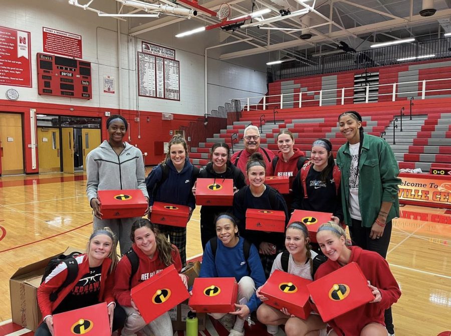 Candace+Parker+%28upper+right%29%2C+Central+alumna+and+WNBA+player%2C+gifts+basketball+shoes+to+varsity+girls+basketball+team+members+after+their+win+against+Benet+Academy+on+Nov.+26.