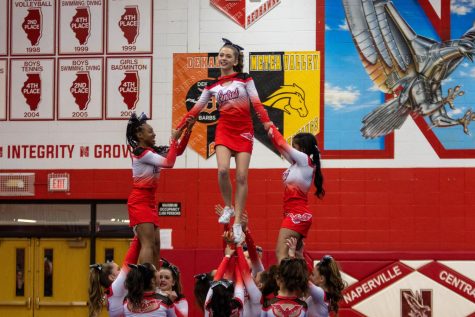 Junior varsity cheerleaders  Cianna Rist (left) and Shariah Grear (right) supports Joise Schretter (center) for a pyramid during their DVC competition at Central on Jan. 7. Centrals junior varsity and varsity teams both placed third at the competition. 