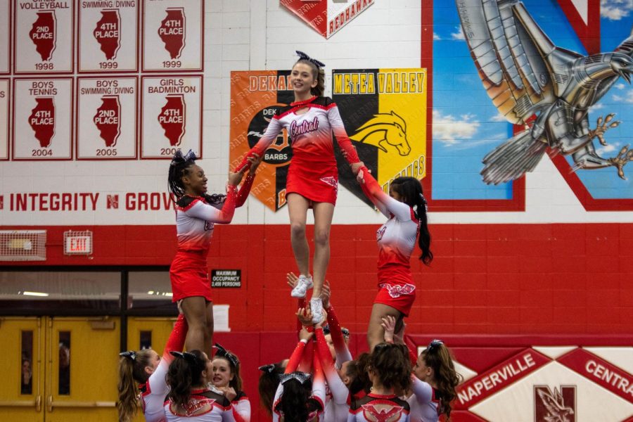 Junior varsity cheerleaders  Cianna Rist (left) and Shariah Grear (right) supports Joise Schretter (center) for a pyramid during their DVC competition at Central on Jan. 7. Centrals junior varsity and varsity teams both placed third at the competition. 