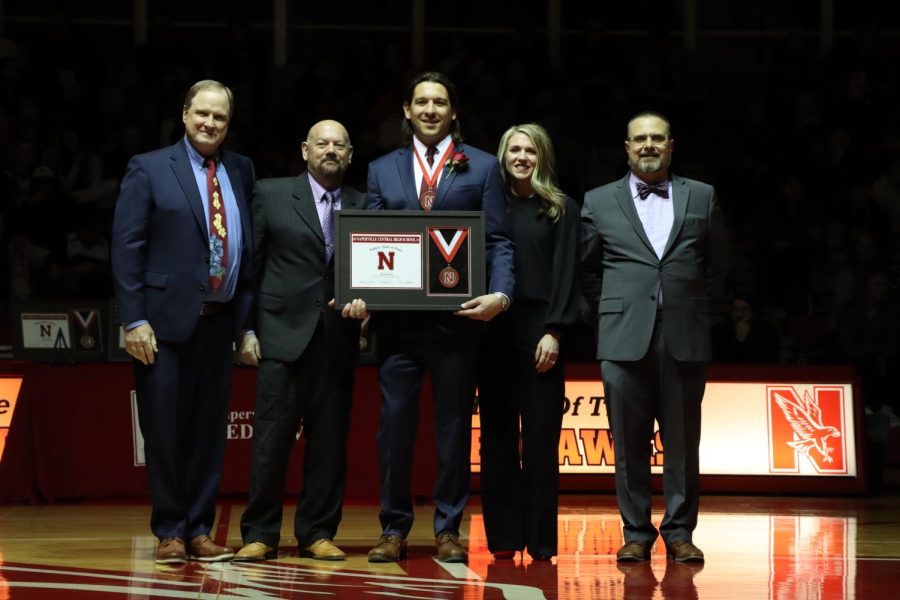 Mark Menis holds hall of fame plaque after receiving it on Feb. 3. 