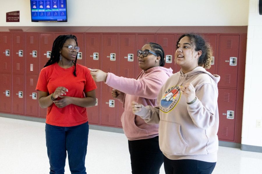 Juniors Chizzy Akubue, Brooklyn Hinton and Lily Robinson (left to right) practice filming the HawkTV announcement for Feb. 21 during a Black and Latino Association meeting on Feb. 17. At the meeting, the entire group also finalized the Black History Month dress up days and worked on their plans for the business expo that takes place on Feb 24 during lunch hours.