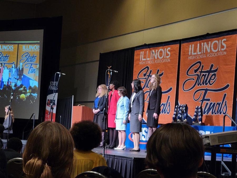 Junior Athena Chen stands onstage during speech state awards on Feb. 18. 