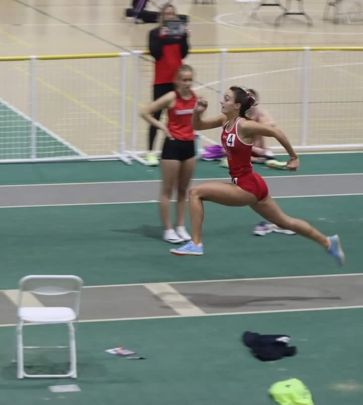 Junior+Brooke+Sawatzky+jumps+the+triple+jump+at+the+York+High+School+invite+on+Feb.17+where+she+placed+first+individually+and+the+team+placed+first+overall.+