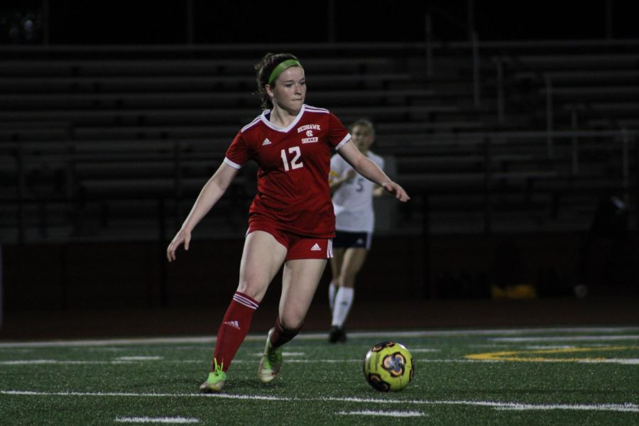 Senior Anna Sadowski dribbles the ball during their game against  Neuqua Valley on April 8. 