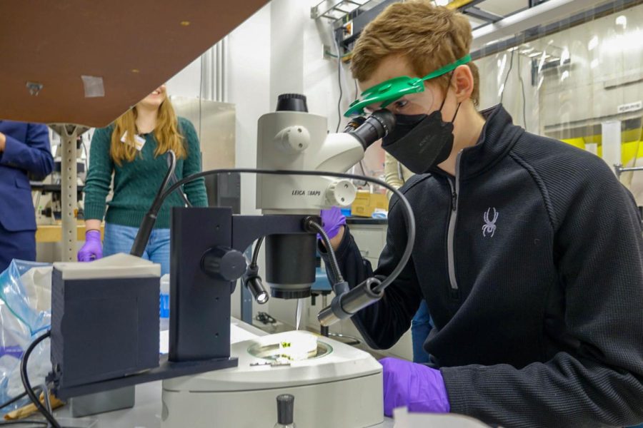 Senior Patrick Kulaga, who also participated in Exemplary Student Research Program as a junior, looks at a plant petri dish through a microscope on the students’ visit to Argonne on Feb. 4. 