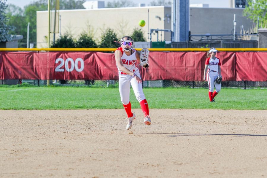 9: Freshamn Natalie Lau throws the ball to first during a softball game against West Chicago on May 3. 
With Lau being perfectly centered in the middle of the frame, the ball being in focus and no blur, this easily deserves ninth place on our list.