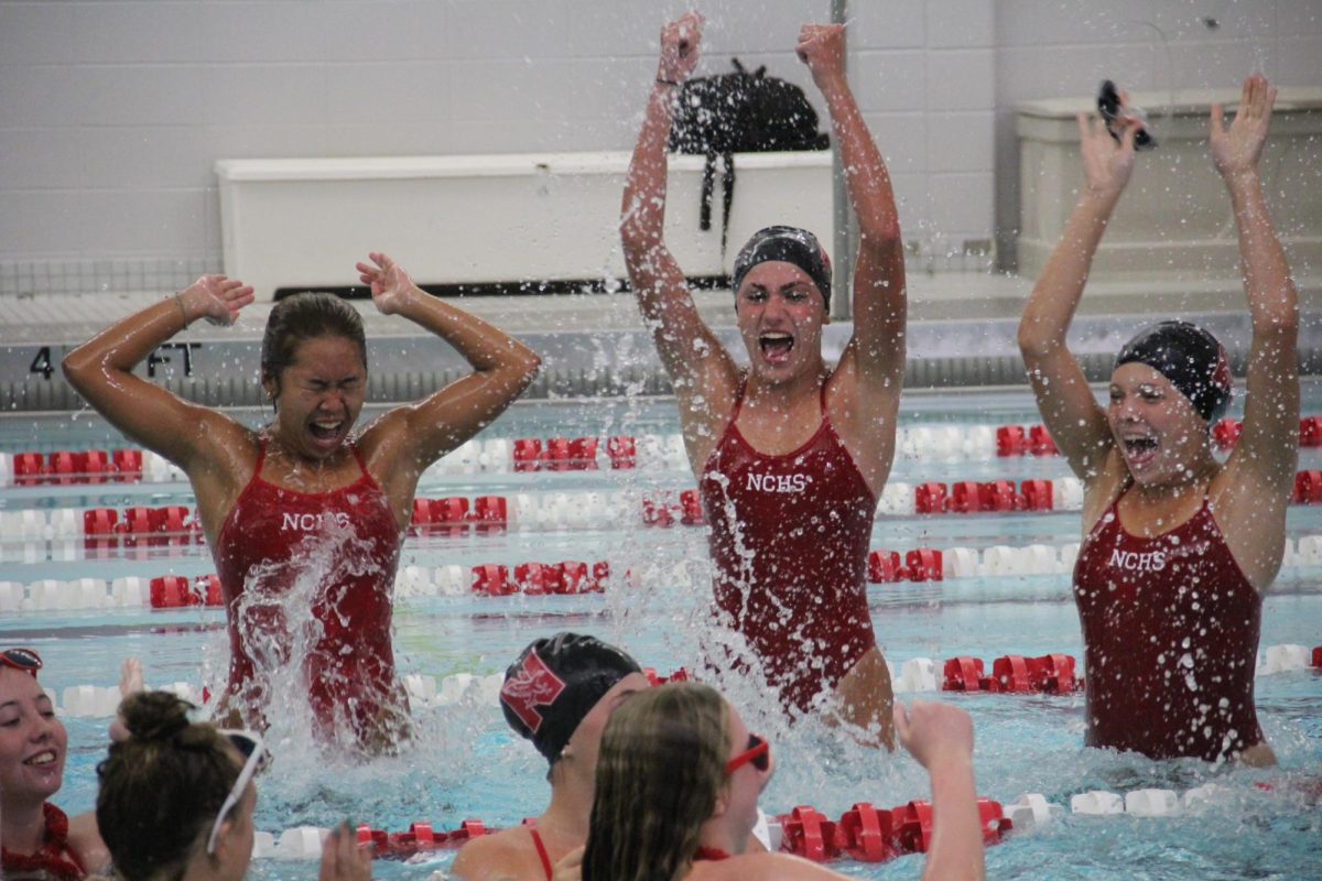 Members+of+the+girls+swim+team+celebrate+in+the+water+at+their+scrimage+on+Centrals+Red+and+White+Night.