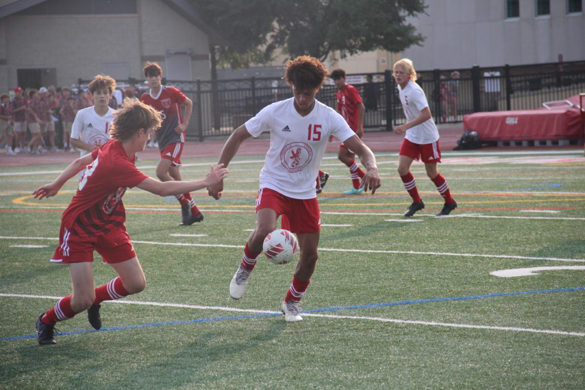 Varsity soccer forward and senior Jonathan Stohner dribbles the ball during the varsity soccer scrimage at Centrals Red and White Night. 