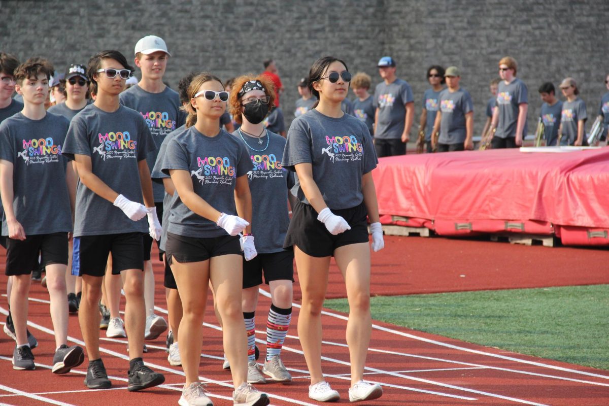 Drum majors and seniors Bianca Cima (front left), and Athena Chen (front right), lead Centrals marching band onto the field for their performance at Centrals Red and White Night.