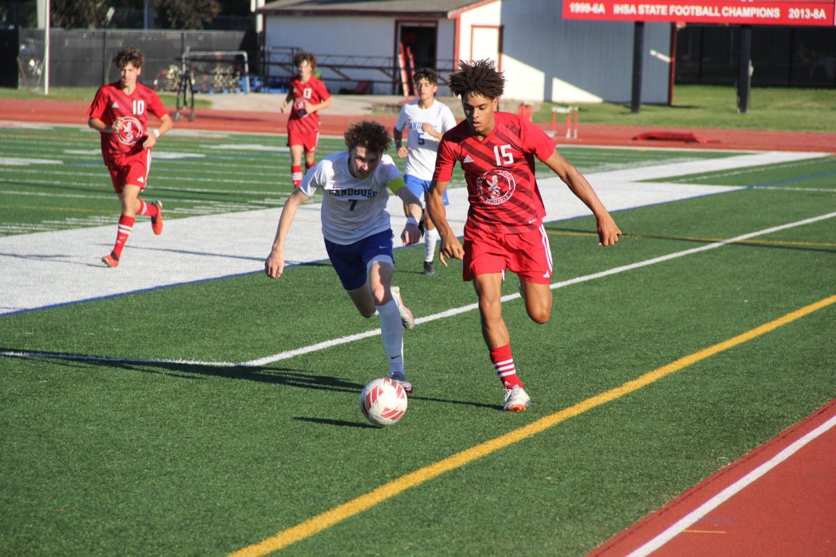 Senior forward Jonathan Stohner fights for the ball with Sandburg opponent during a game that resulted in a Central win on Aug. 31. Stohner is one of the few Varsity players in their same position as last year. 