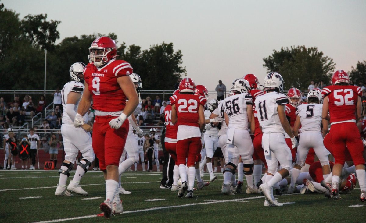 Defensive end Maverick Ohle (9), a senior, celebrates a defensive stop in Central's game against Plainfield North on Sept. 1. The Redhawks went on to win the game 6-3.