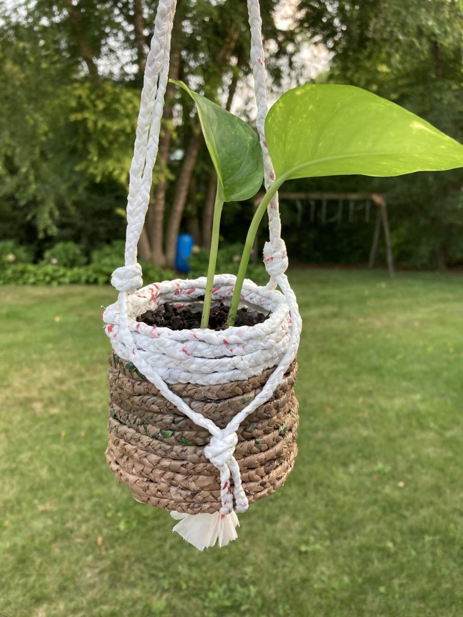 Zoey Tian wove white and brown plastic bags to create a hanging pot. 