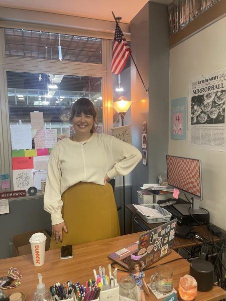 Emily Rigik stands near her Mirrorball poster. 