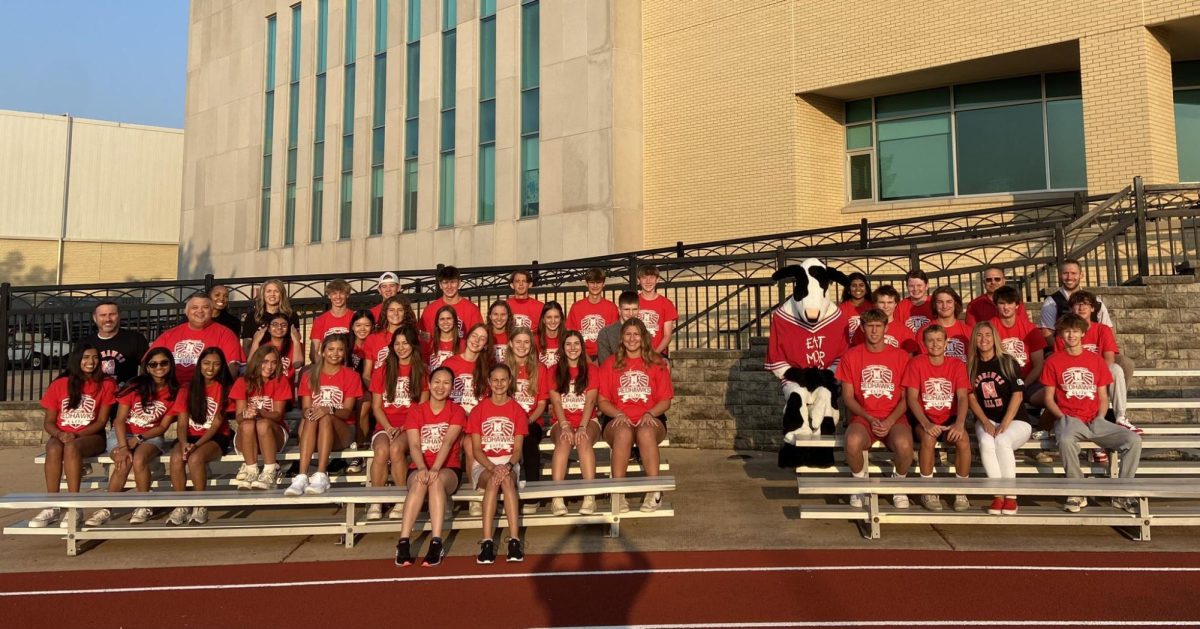 Members+of+Redhawk+ELITE+pose+for+a+photo+with+the+Chick-Fil-A+mascot+at+an+event+on+Aug.+18