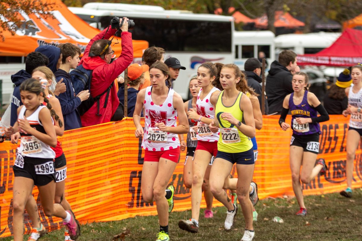 Senior Liv Phillips, wearing bib number 2025, races during the 2022 IHSA Cross Country State Finals. The Redhawks would end up placing sixth in the 3A class.