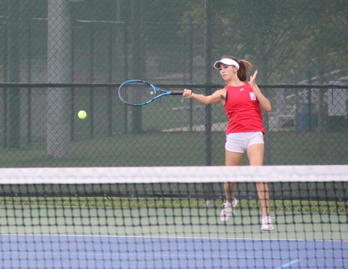 Junior Sofia Olaru hits the ball during a match against Metea Valley High School on Sept. 28. 