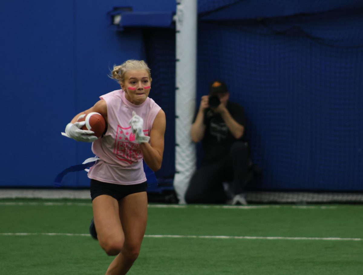 Junior Brooke Bilik runs the ball at a “Powderpuff” flag football tournament organized by two Central seniors on Nov. 12.