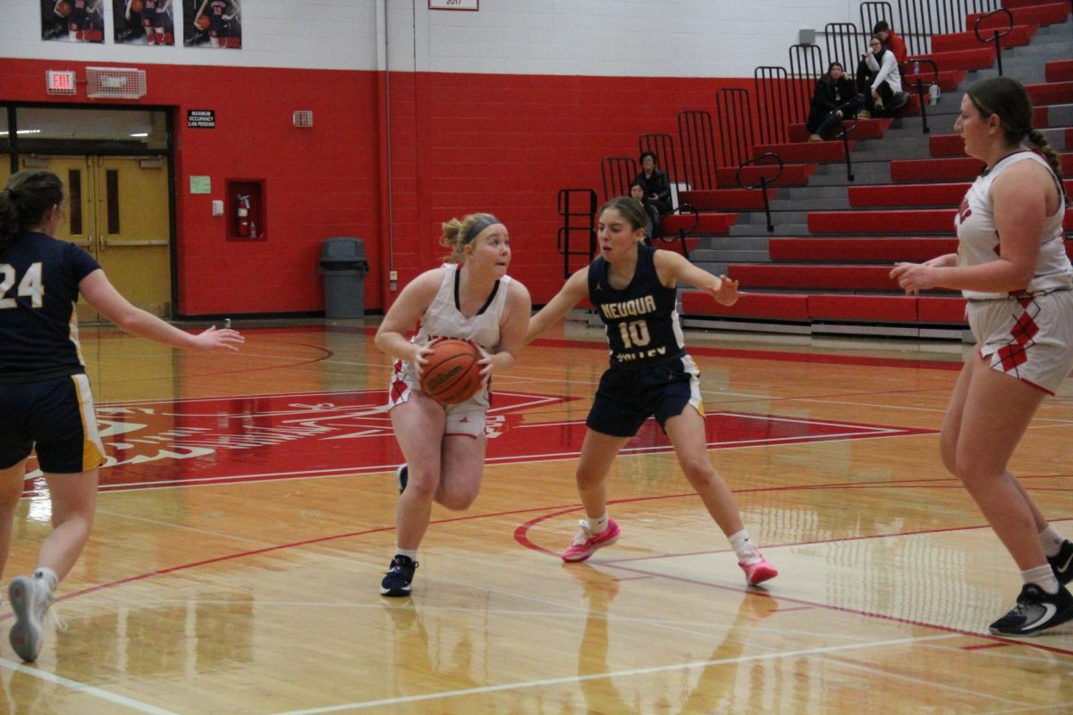 Running down the court, sophomore Ava Rybarczyk looks to make a basket during a game against Neuqua Valley on Dec. 7. The teams current record is 2-8. 