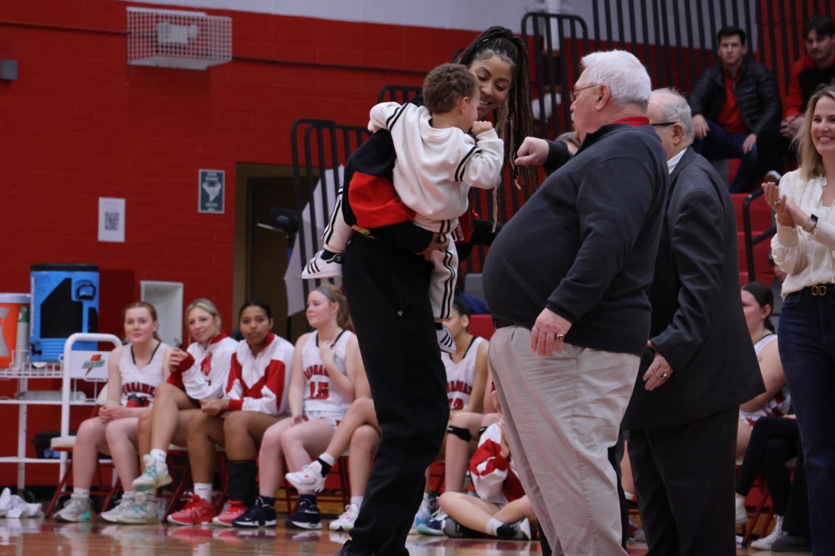 Central alumni and WNBA player Candice Parker (left) steps forward to be honored during a halftime ceremony on Jan. 27.