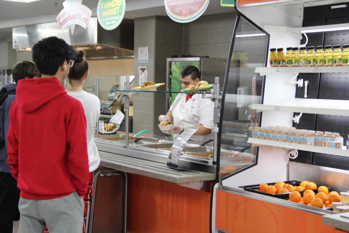 Central students wait to pick up food from Central's cafe. Central's food is provided by OrganicLife, who are in their first year as District 203's food service provider.