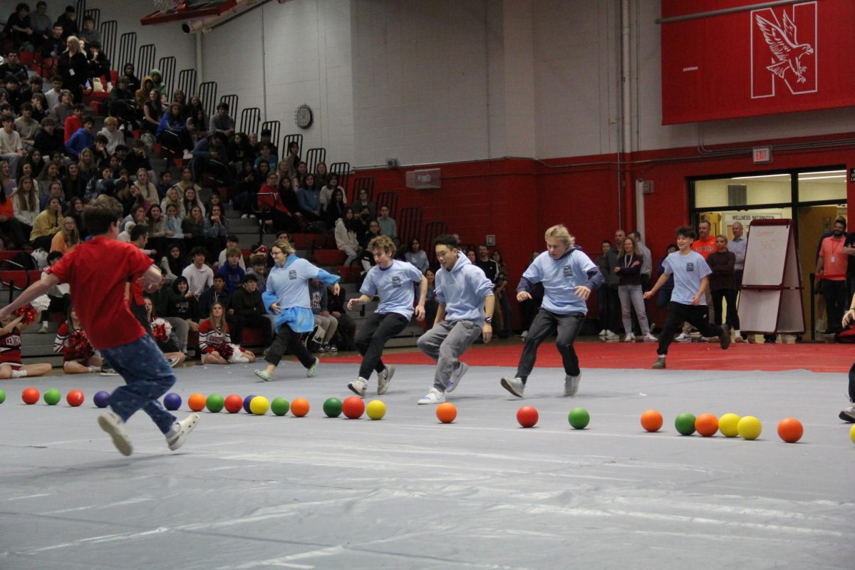 Members of the sophomore dodgeball team run to collect balls during the Feb. 5 winter week assembly.