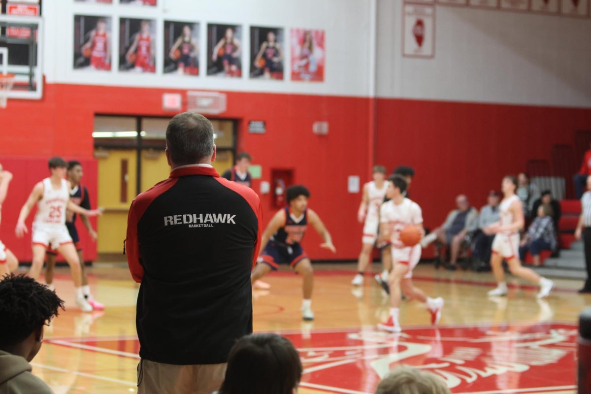 Boys basketball head coach Pete Kramer watches his team during their 51-43 victory over Oswego in the IHSA Regional Quarter Final on Feb. 19.