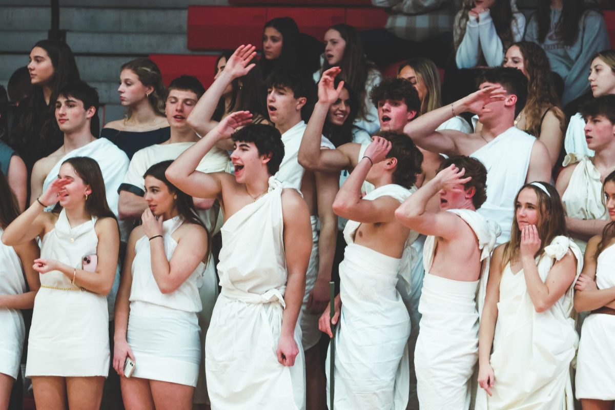 The+student+section+celebrates+at+a+Central+Basketball+game+versus+Oswego+on+Feb.+19.