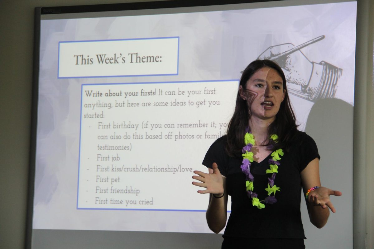 Junior Emma Dram, Poetry Club co-president and co-founder, speaks at the group's first meeting in Room 200 on Aug. 25.