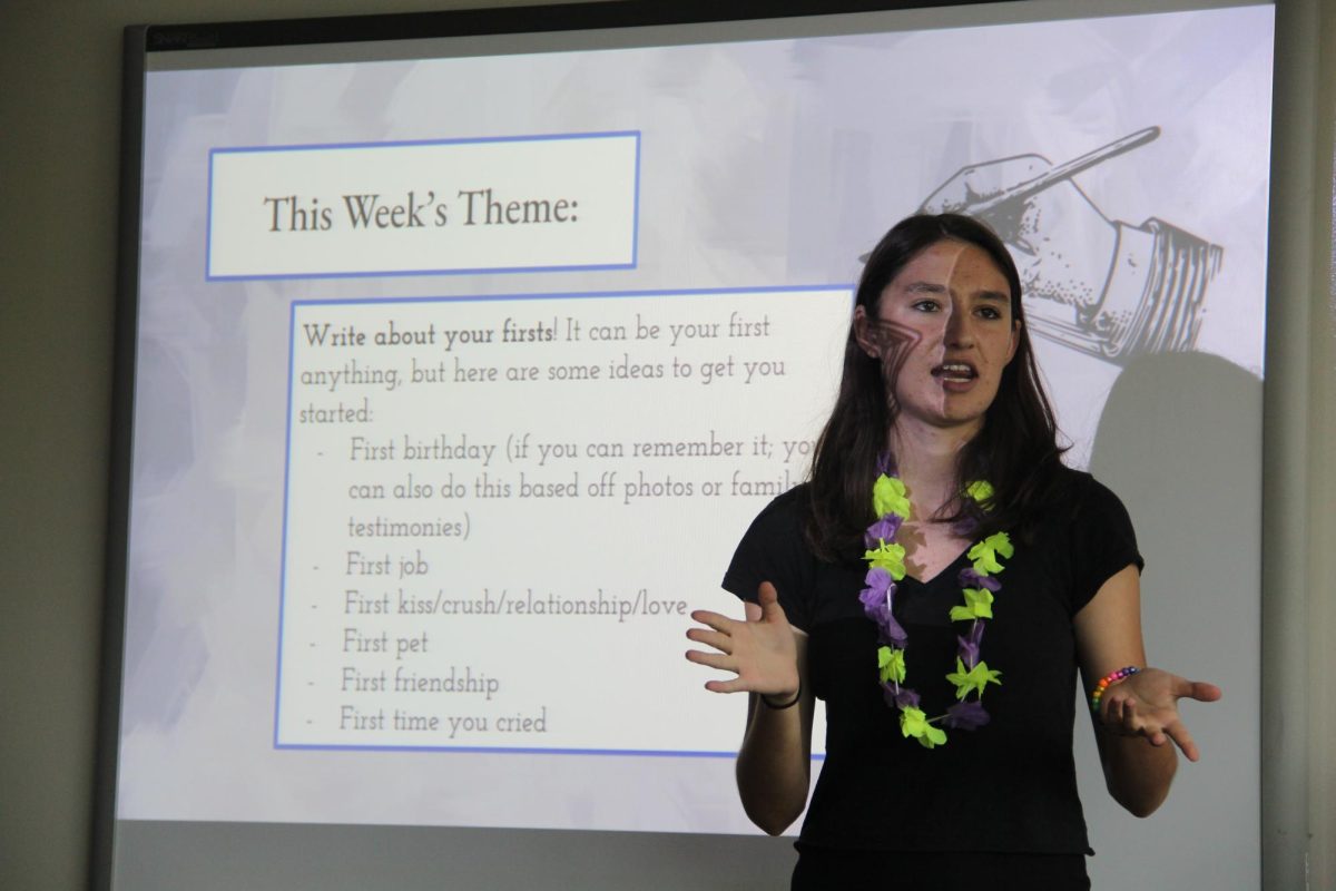 Junior Emma Dram, Poetry Club co-president and co-founder, speaks at the groups first meeting in Room 200 on Aug. 25.