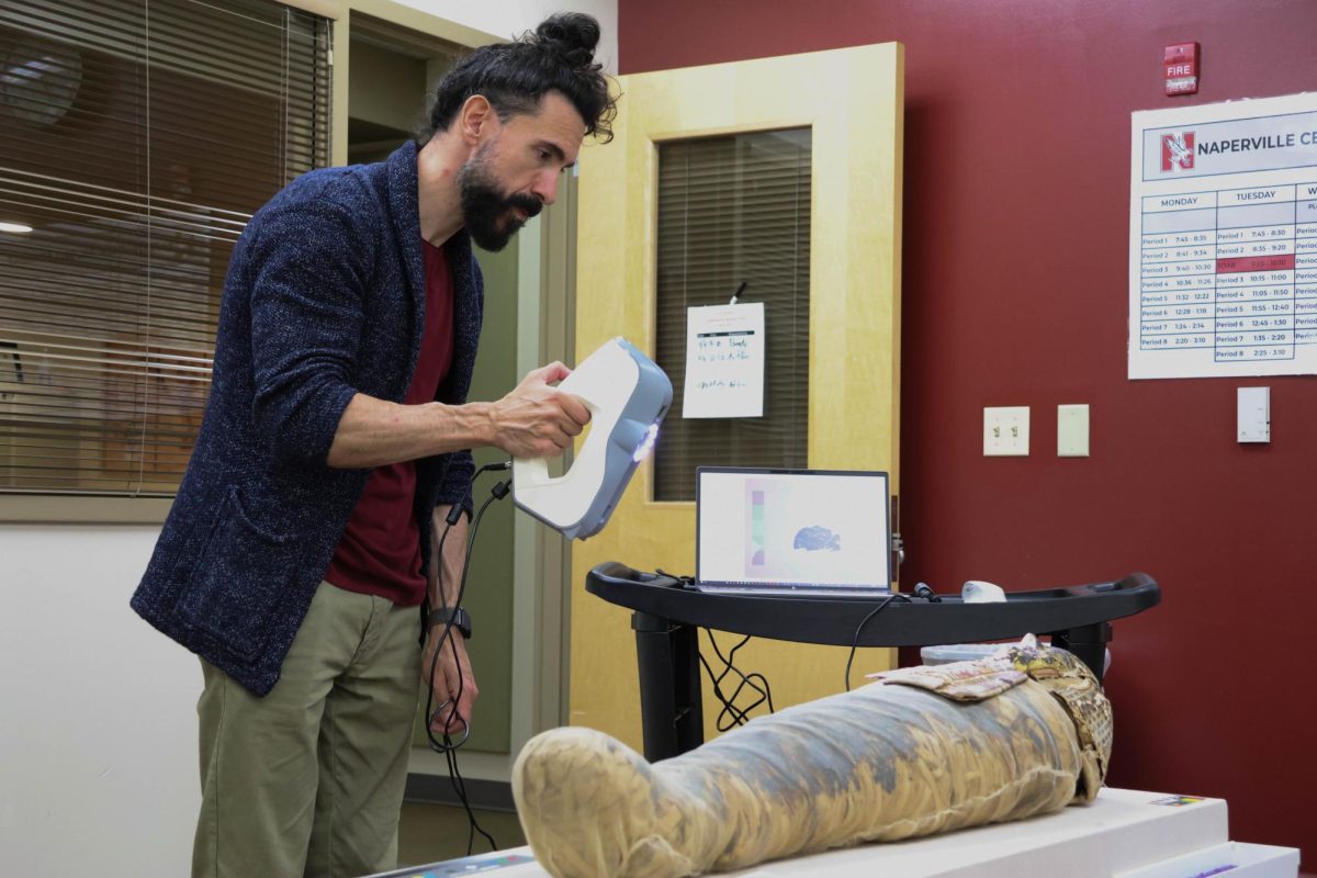 Carlo Rindi Nuzzolo, a Marie Skłodowska Curie Actions Post-Doctoral Global Fellow, performs a 3D scan of Naperville Central's ancient Egyptian mummy.