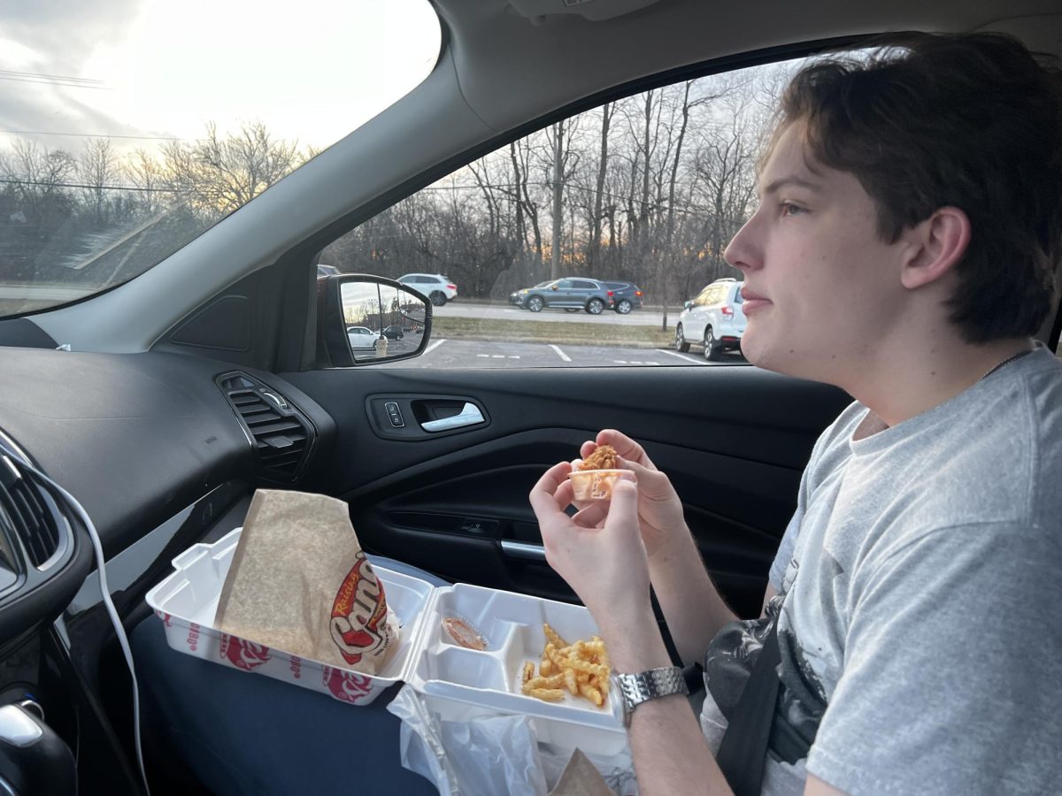 Senior Miles Murphy eats while waiting hours for his target.