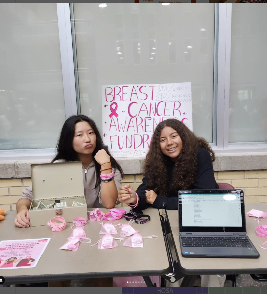 Sophomores+Amy+Yang+and+Claire+Cameron+fundraise+to+support+breast+cancer+awareness+during+a+lunch+period+on+Oct.+19+for+Health+Occupations+Students+of+America+%28HOSA%29.+