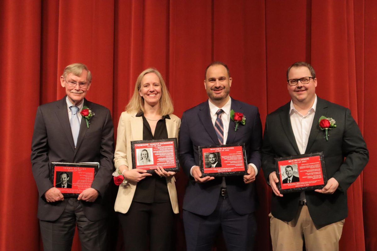 From left to right, Robert Zoellick, Dr. Catherine Adrian DeRidder, Matt DiCianni and Ben Hutchison pose after becoming Central’s newest Distinguished Alumni at a ceremony on May 3.