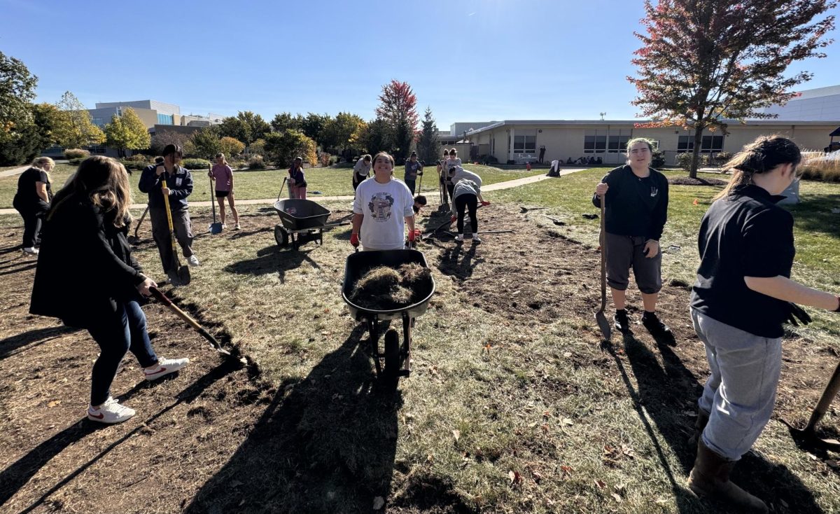 Humanities Capstone students work to skim sod and turn over soil, planting 37 different species of trees on Oct. 18.
