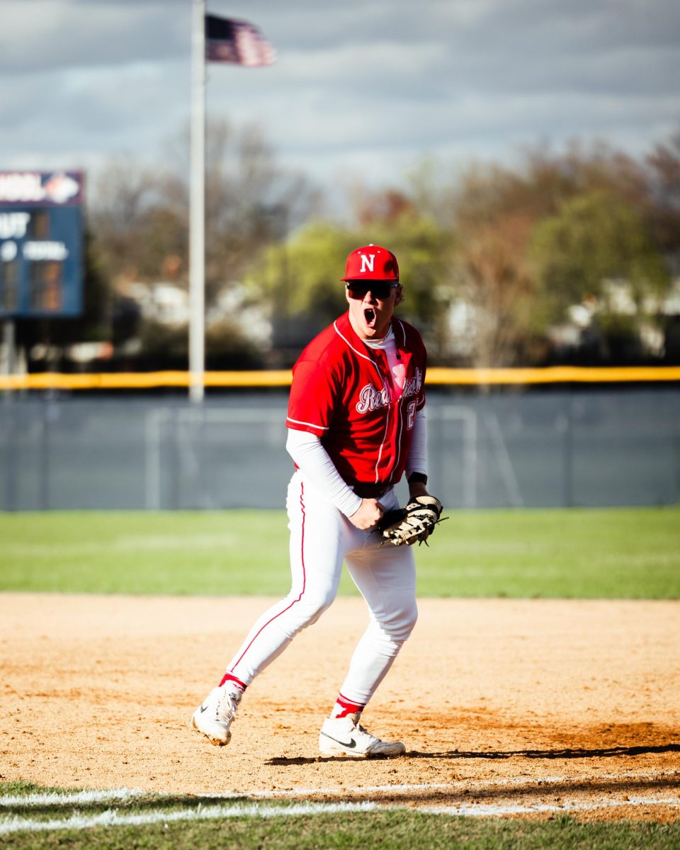 Senior Troy Kashul celebrates at a game against North after the Redhawks made a double play to end the inning. The Redhawks ended up losing the series 1-2. 