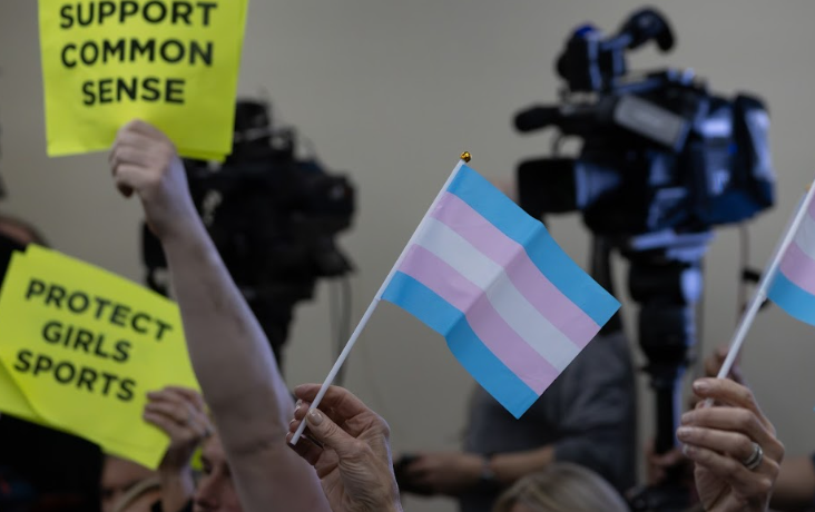 Signs held at the public comments portion of the District 203 School Board meeting on May 19. Support and criticism of a recent junior high track meet are highlighted by signs held by the audience.