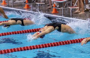 At a swim meet hosted by Naperville Central Lexi Goldstone races to the finish. Goldstone propels off the wall in order to obtain maximum speed.