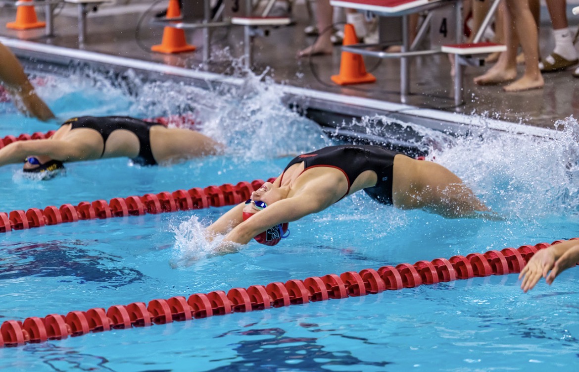 At a swim meet hosted by Naperville Central Lexi Goldstone races to the finish. Goldstone propels off the wall in order to obtain maximum speed. 