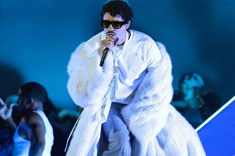 Bad Bunny performed at the iHeartRadio Music Awards 2025. He appears on stage in an eye-catching fur coat. (Photo Credit: Monica Schipper/Getty)