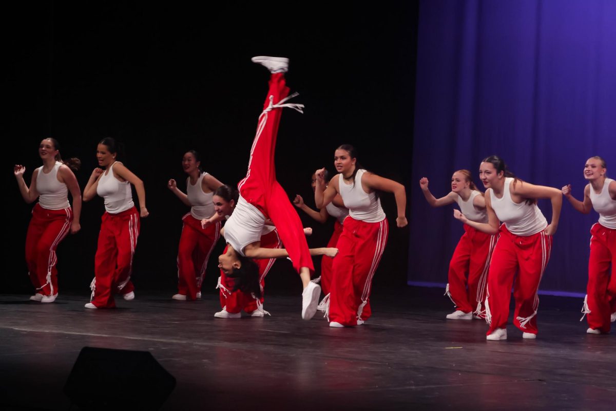 Sophomore dancer Amisha Narahari launches into an aerial during Naperville Central’s Orchesis showcase, highlighting the athleticism and technique featured throughout the performance.