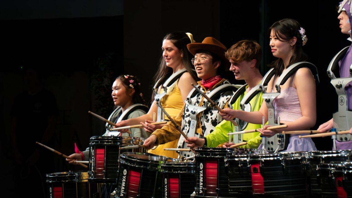Drumline looks out to the crowd while preforming at the annual drumshow on April 10 and 11. The theme for this year, Once Upon a Drumshow, featured arrangements of Disney and Pixar soundtracks.