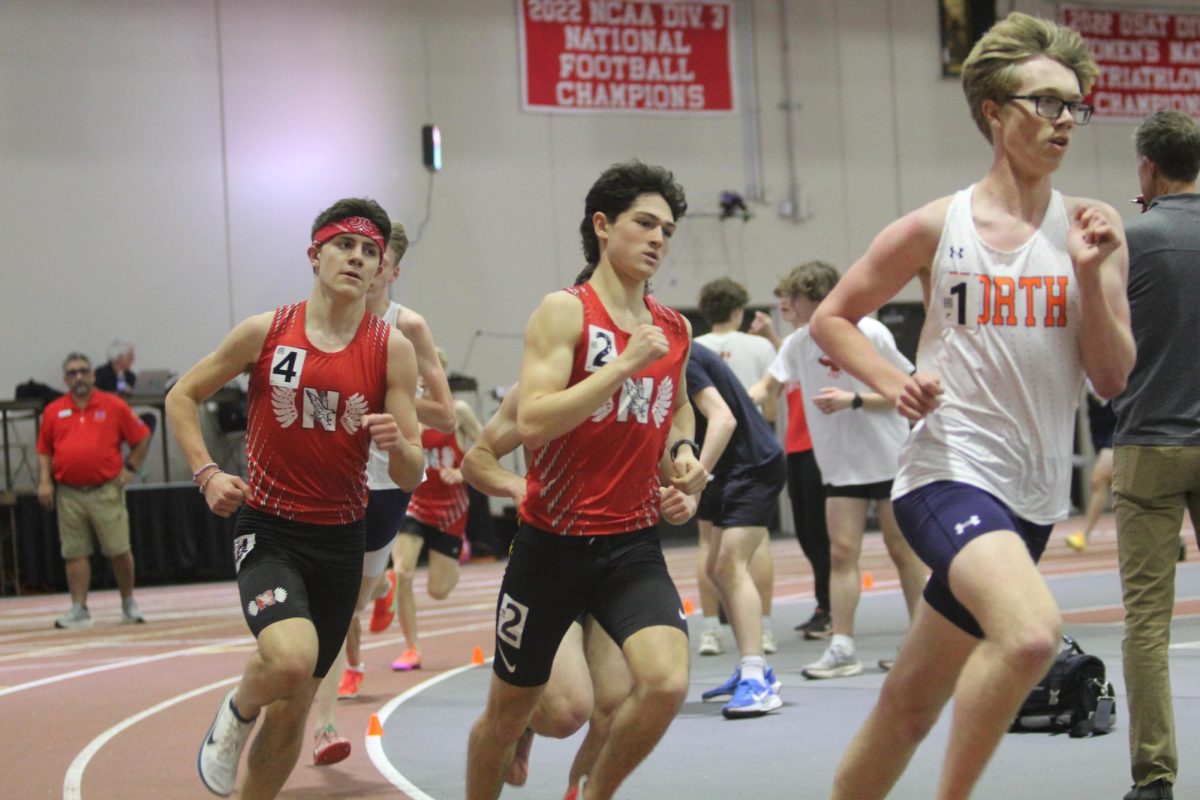 Junior Derek Williamson (right) and Sophomore Jack Anderson (left) chase down 1600 meter leader.