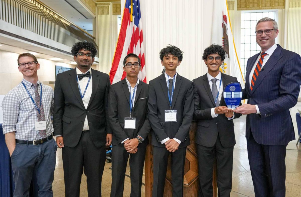 Mr. Michael Borge, Economics Teacher and club sponsor, junior Taran Nathan, junior Krish Patel, junior Harsh Pate, senior Rohan Jain and State Treasurer Mike Frerichs pose for a photo. This team of four Naperville Central students from the NCHS Finance Club placed first at the Illinois Personal Finance Challenge on April 14. Photo Credit: Rohan Jain